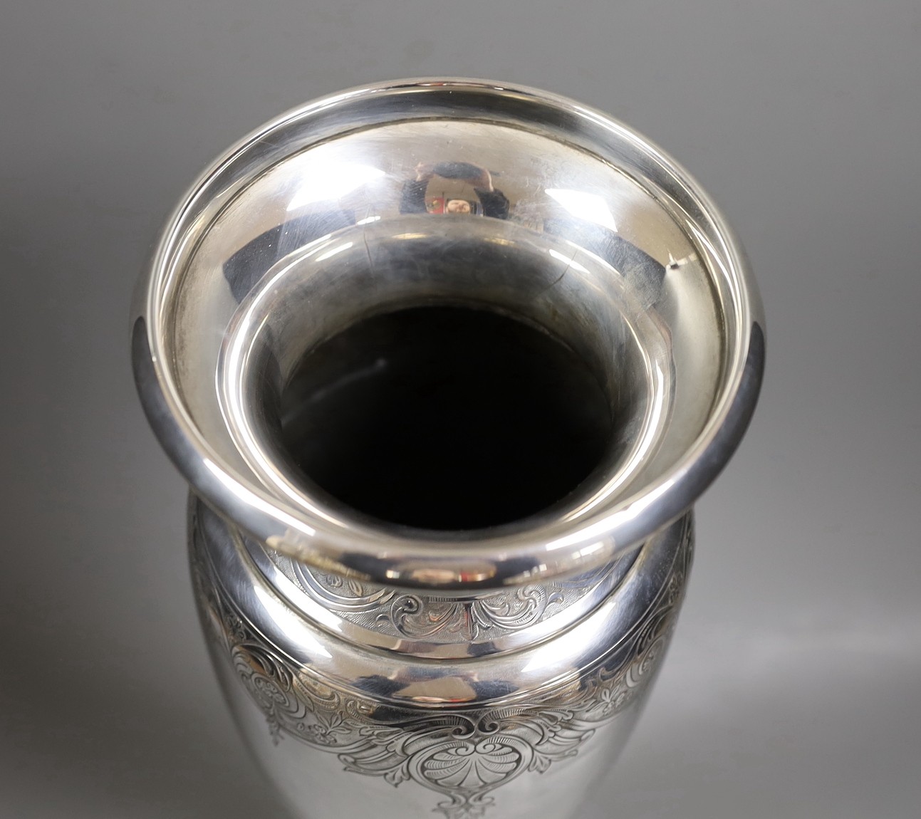 A North American sterling tall vase, with engraved decoration, 40.6cm, weighted.